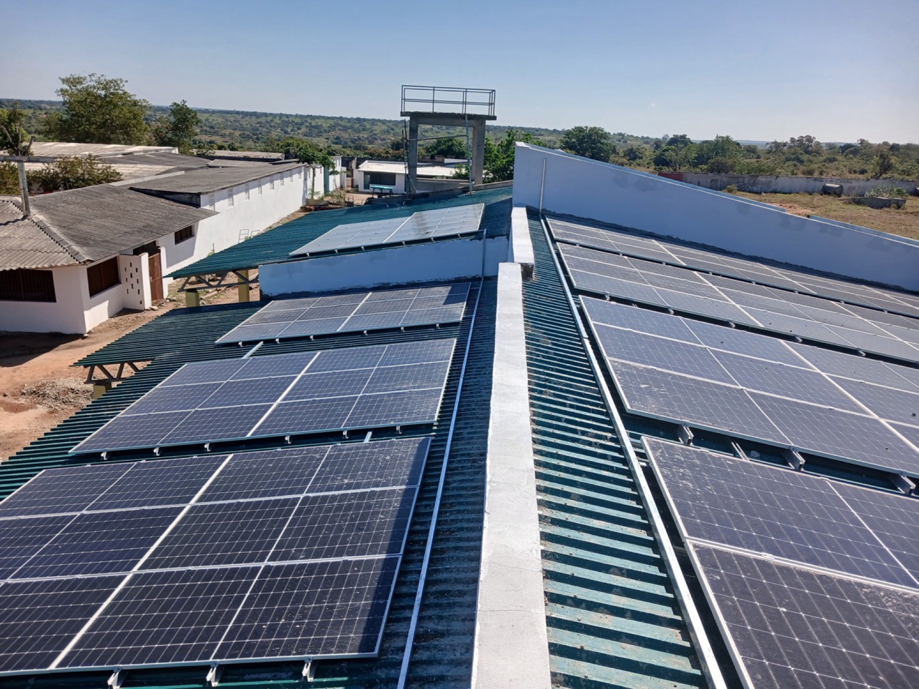 Multiple rooftop solar arrays installed across an operational site